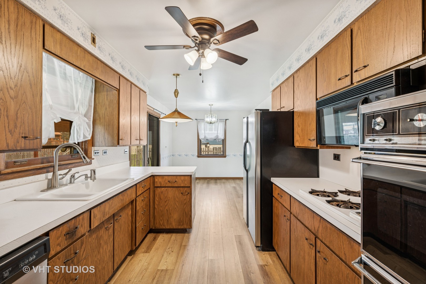 452 Miller Street Beecher, IL 60401 - Photo 4 of 20 a kitchen with stainless steel appliances a sink cabinets and wooden floor