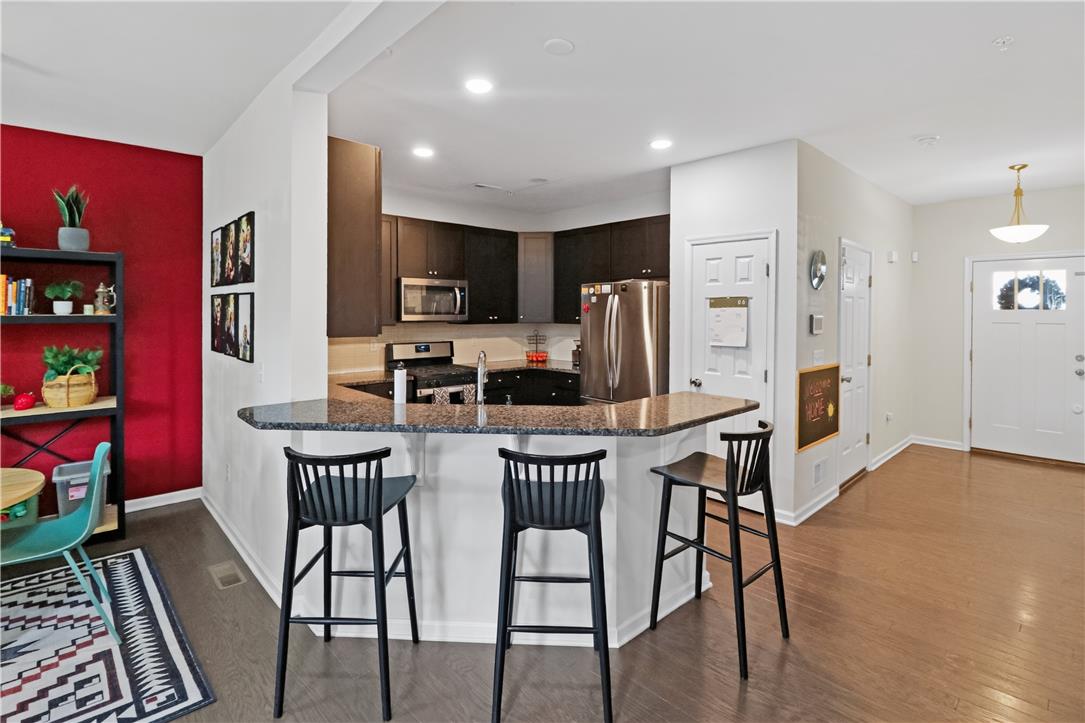 4502 Benjamin Court Emmaus, PA 18049 - Photo 9 of 48 Granite counters and stainless steel appliances complete this inviting kitchen, perfect for casual dining.