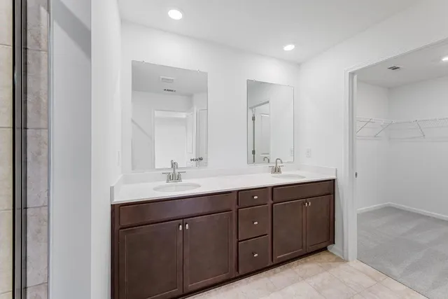 a bathroom with double sink and mirror