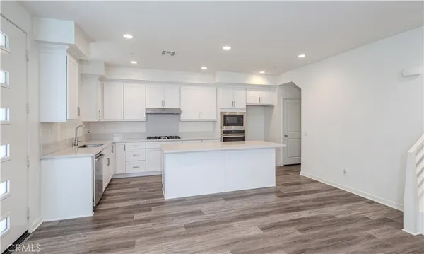a kitchen with stainless steel appliances refrigerator stove microwave and cabinets