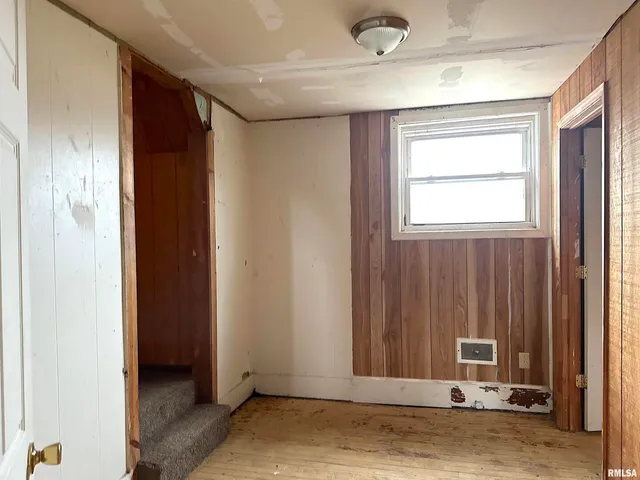a view of a livingroom with wooden floor and a window