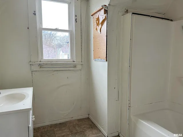a bathroom with a shower and a sink