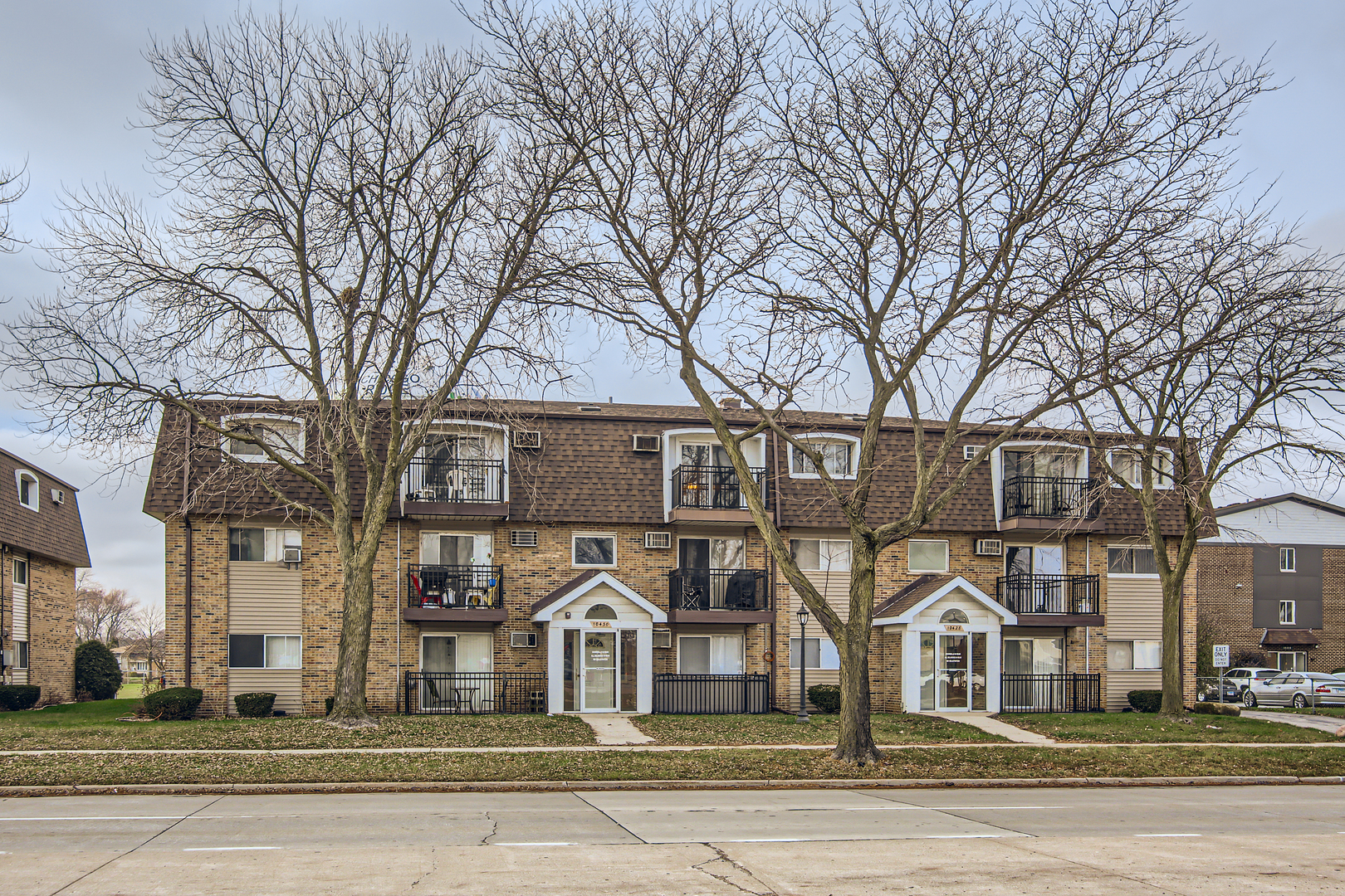 10430 Ridgeland Avenue, Unit 12 Chicago Ridge, IL 60415 - Photo 1 of 11 a front view of a residential apartment building with a yard