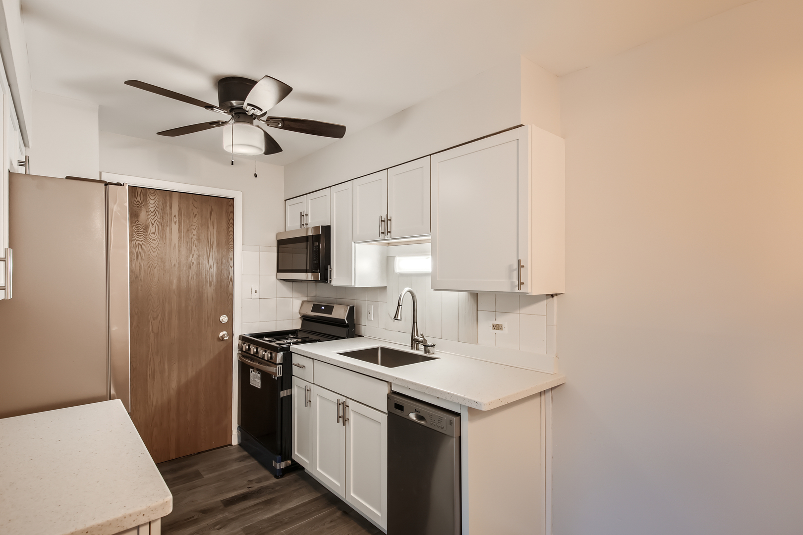 10430 Ridgeland Avenue, Unit 12 Chicago Ridge, IL 60415 - Photo 5 of 11 a kitchen with a sink appliances and cabinets