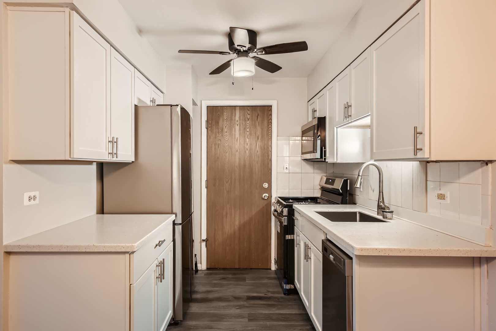 10430 Ridgeland Avenue, Unit 12 Chicago Ridge, IL 60415 - Photo 6 of 11 a kitchen with a sink a stove and a refrigerator