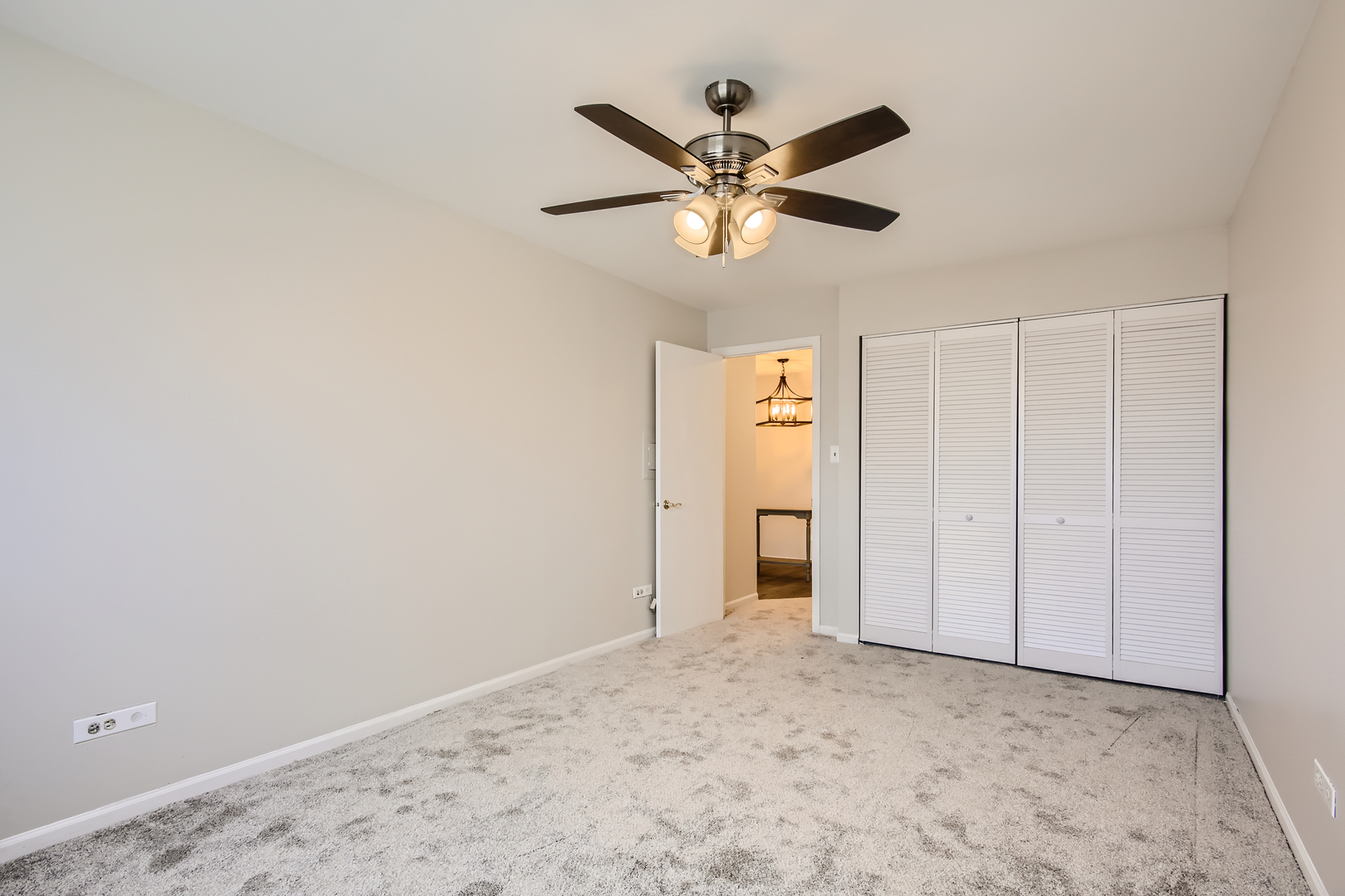10430 Ridgeland Avenue, Unit 12 Chicago Ridge, IL 60415 - Photo 8 of 11 a view of a livingroom with a chandelier fan and closet area