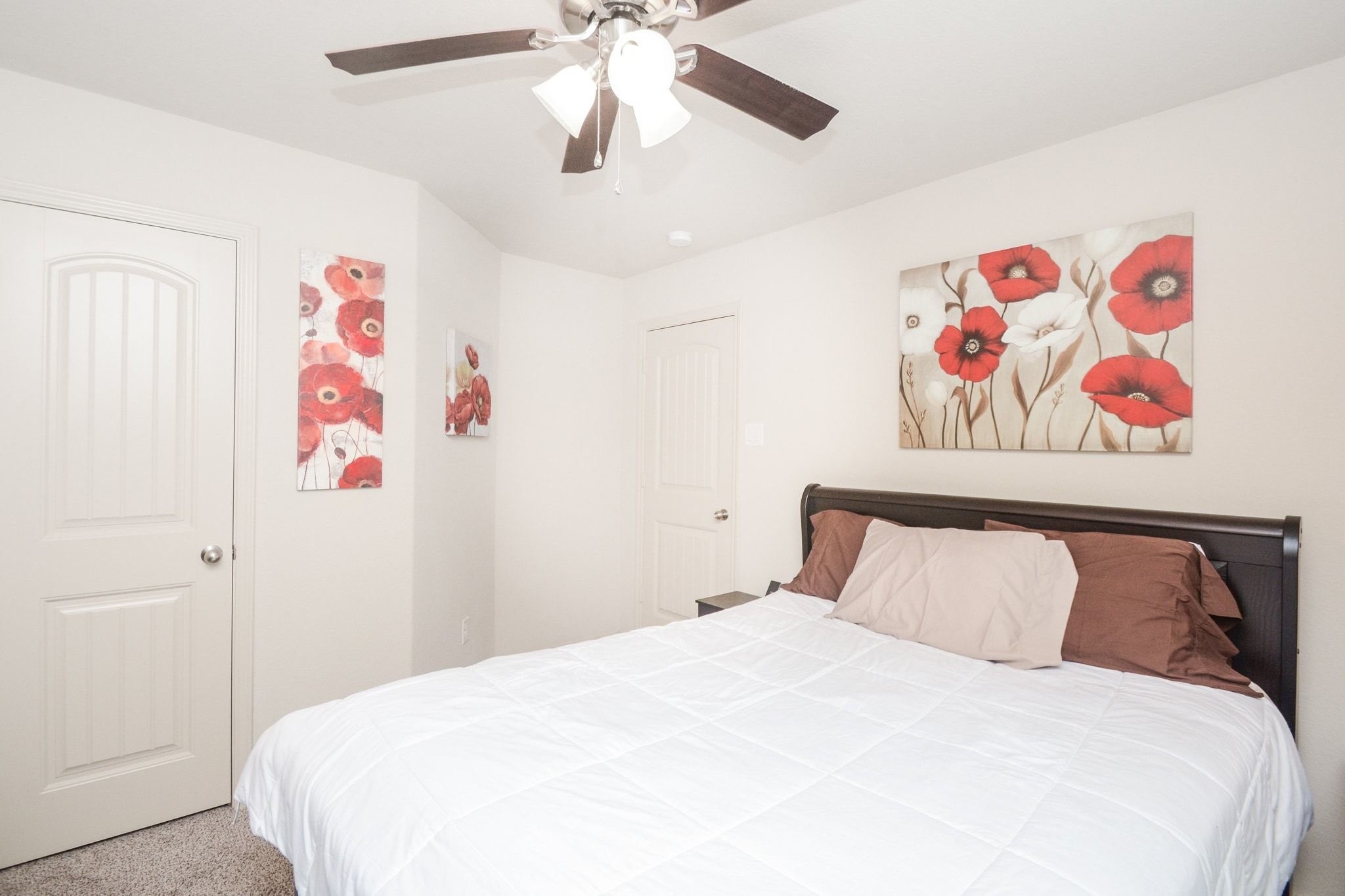 23318 Dukes Run Drive Spring, TX 77373 - Photo 19 of 41 Cozy bedroom featuring neutral walls, a ceiling fan, and a bed. The room is accented with a soft carpeted floor, creating a warm and inviting atmosphere.