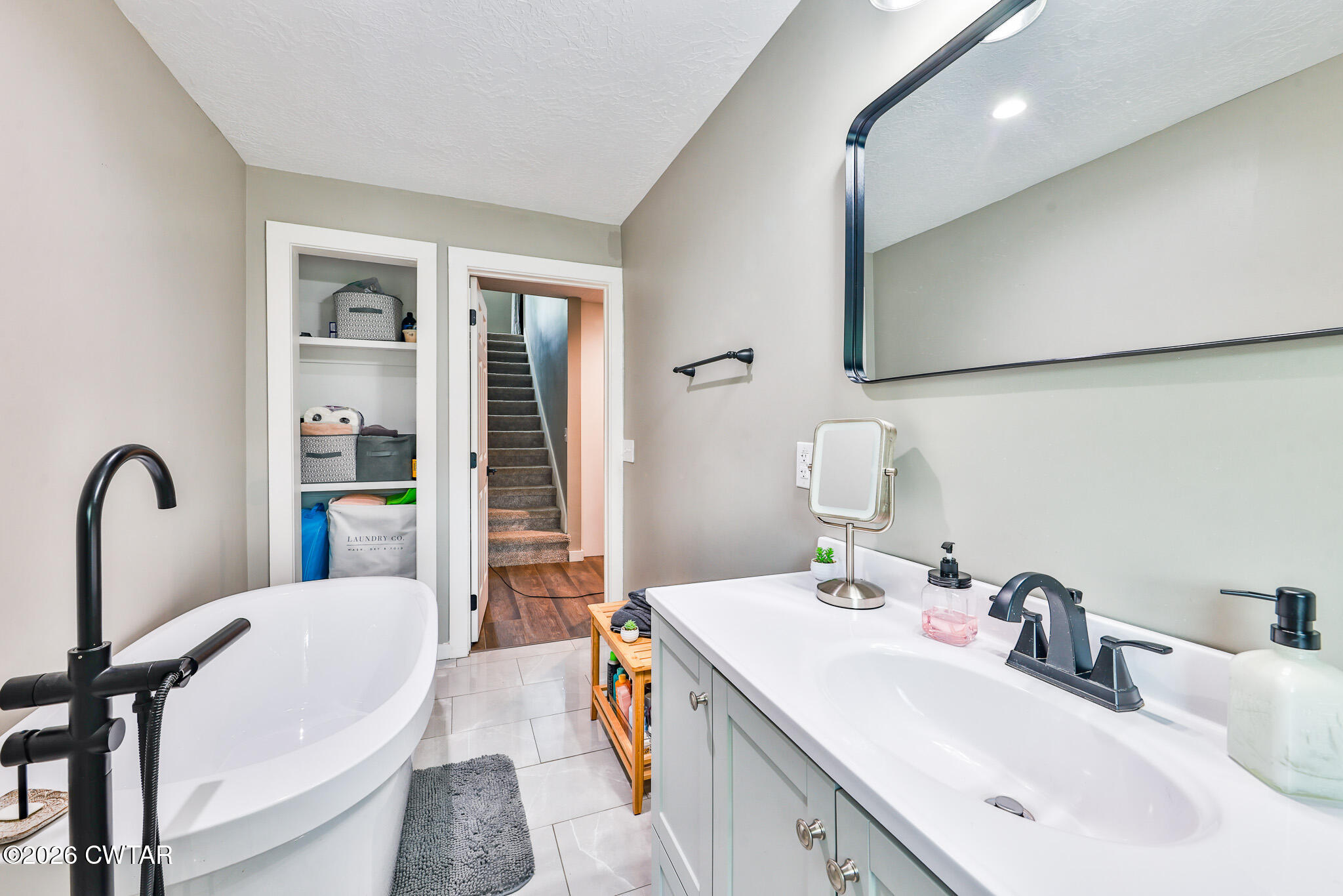 210 East Union Street Gleason, TN 38229 - Photo 13 of 28 a en suite bathroom with a double vanity sink a mirror and a shower