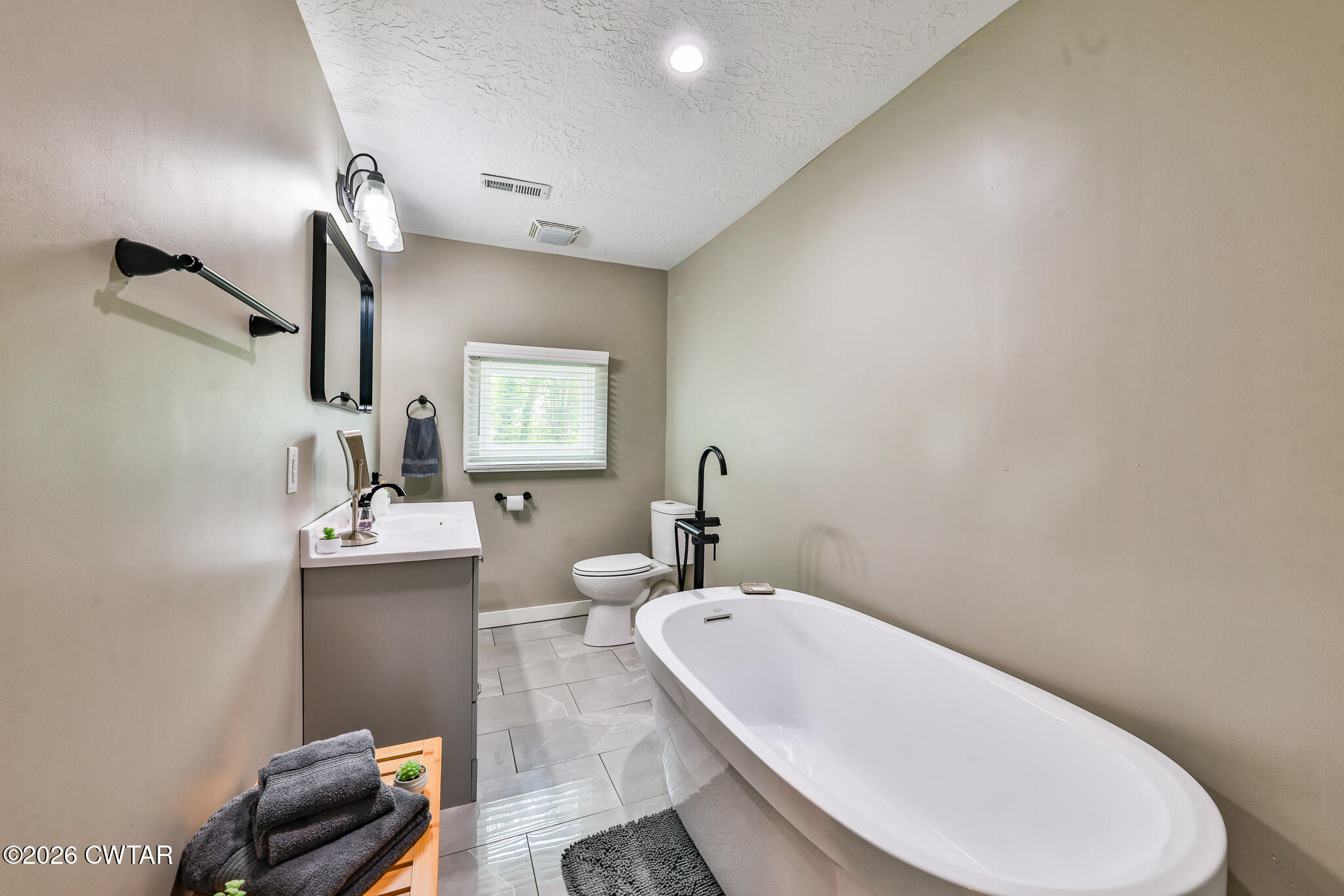 210 East Union Street Gleason, TN 38229 - Photo 14 of 28 a bathroom with a sink a toilet and mirror