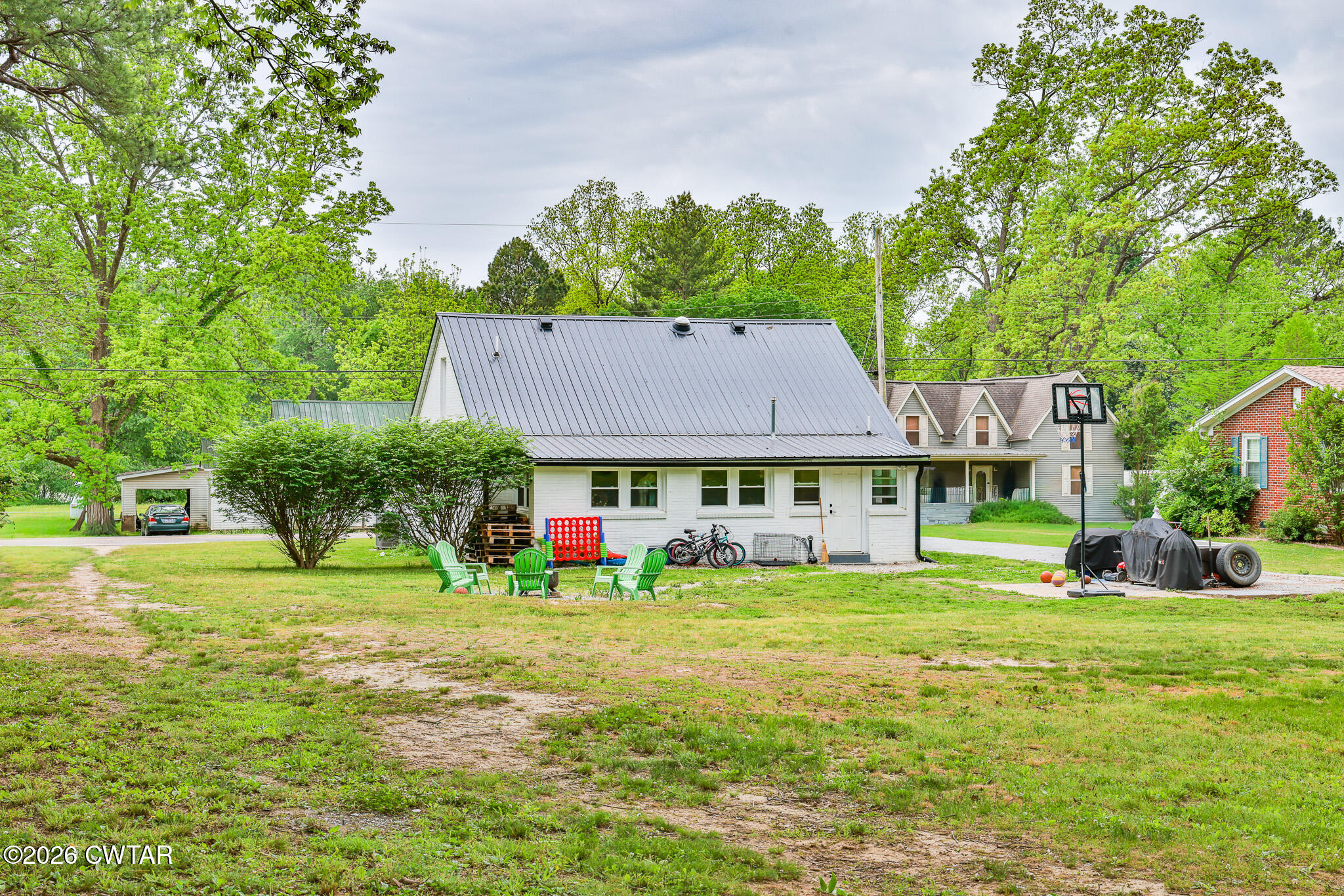 210 East Union Street Gleason, TN 38229 - Photo 23 of 28 a view of a big house with a big yard and large trees