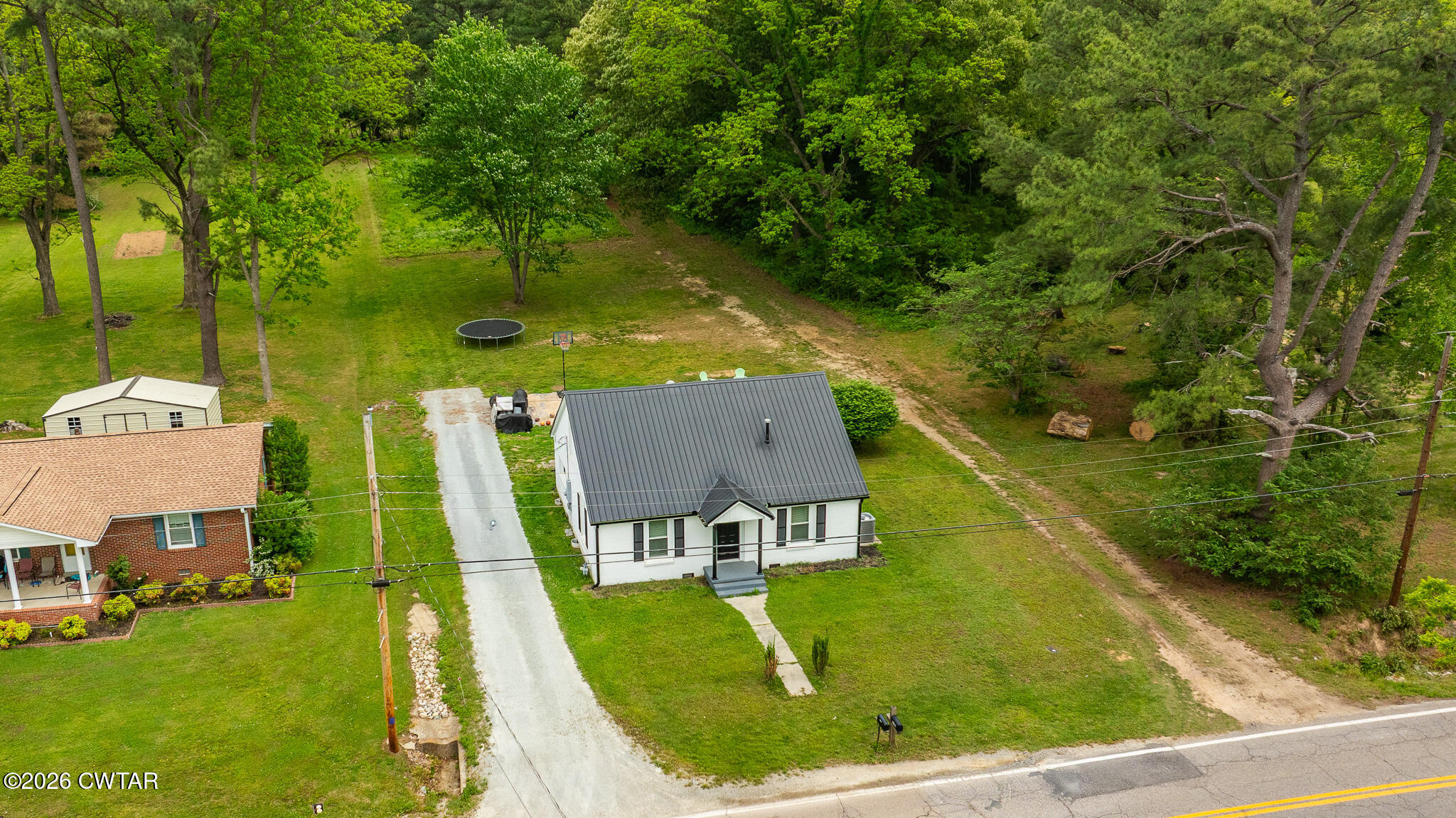 210 East Union Street Gleason, TN 38229 - Photo 28 of 28 an aerial view of residential houses with outdoor space and trees