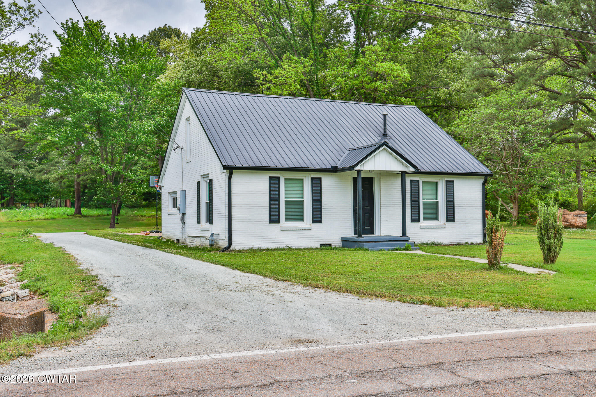 210 East Union Street Gleason, TN 38229 - Photo 5 of 28 a front view of a house with a yard and garage
