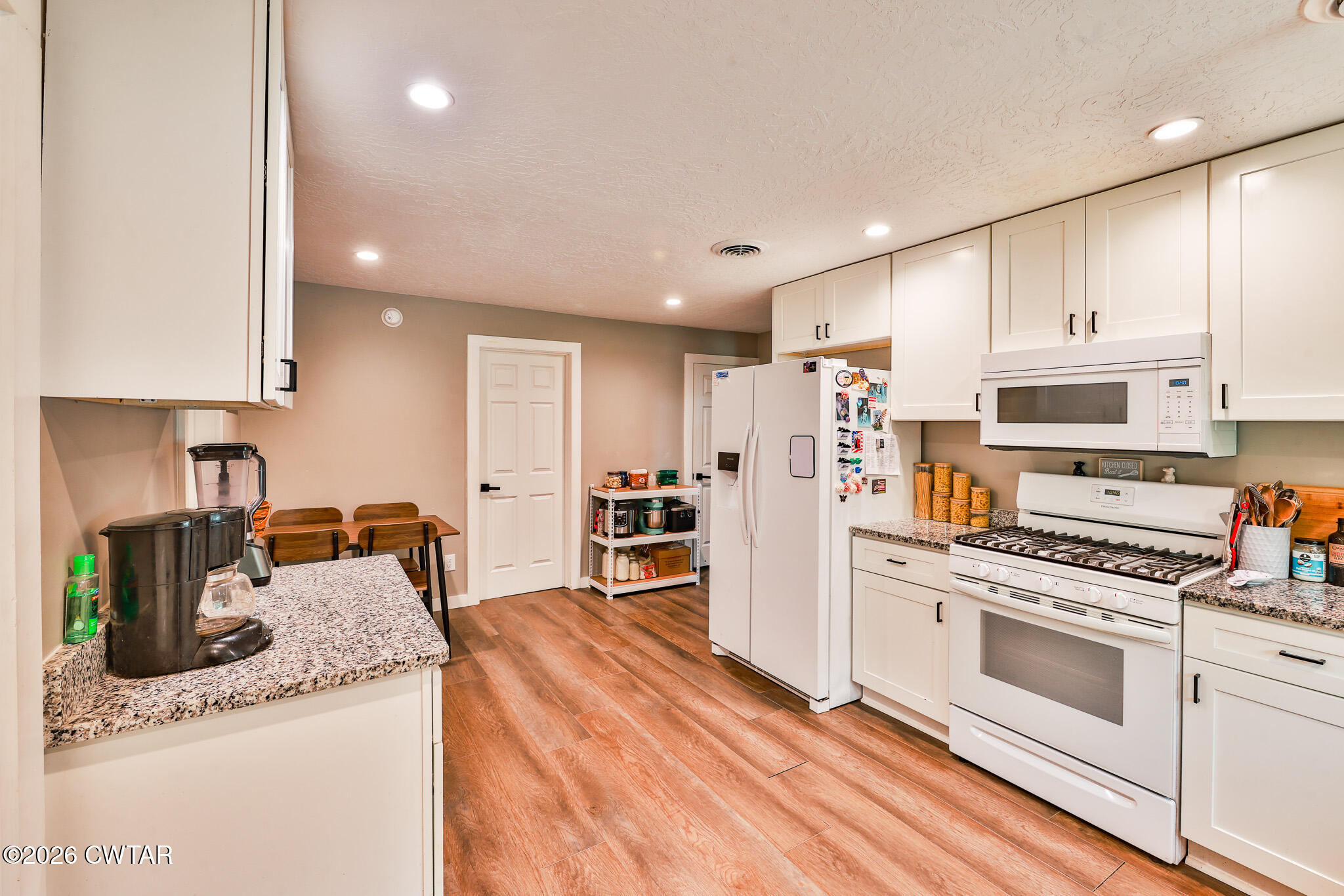210 East Union Street Gleason, TN 38229 - Photo 8 of 28 a kitchen with granite countertop a stove sink and refrigerator