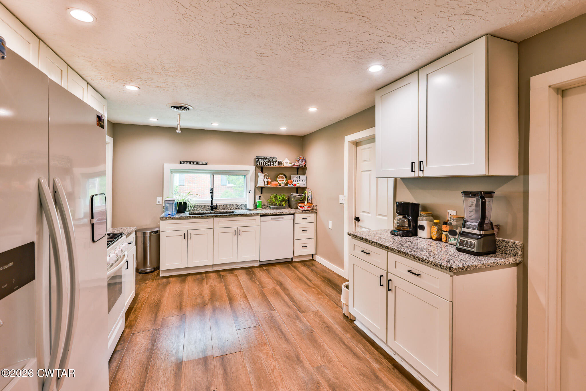 210 East Union Street Gleason, TN 38229 - Photo 9 of 28 a kitchen with white cabinets and stainless steel appliances