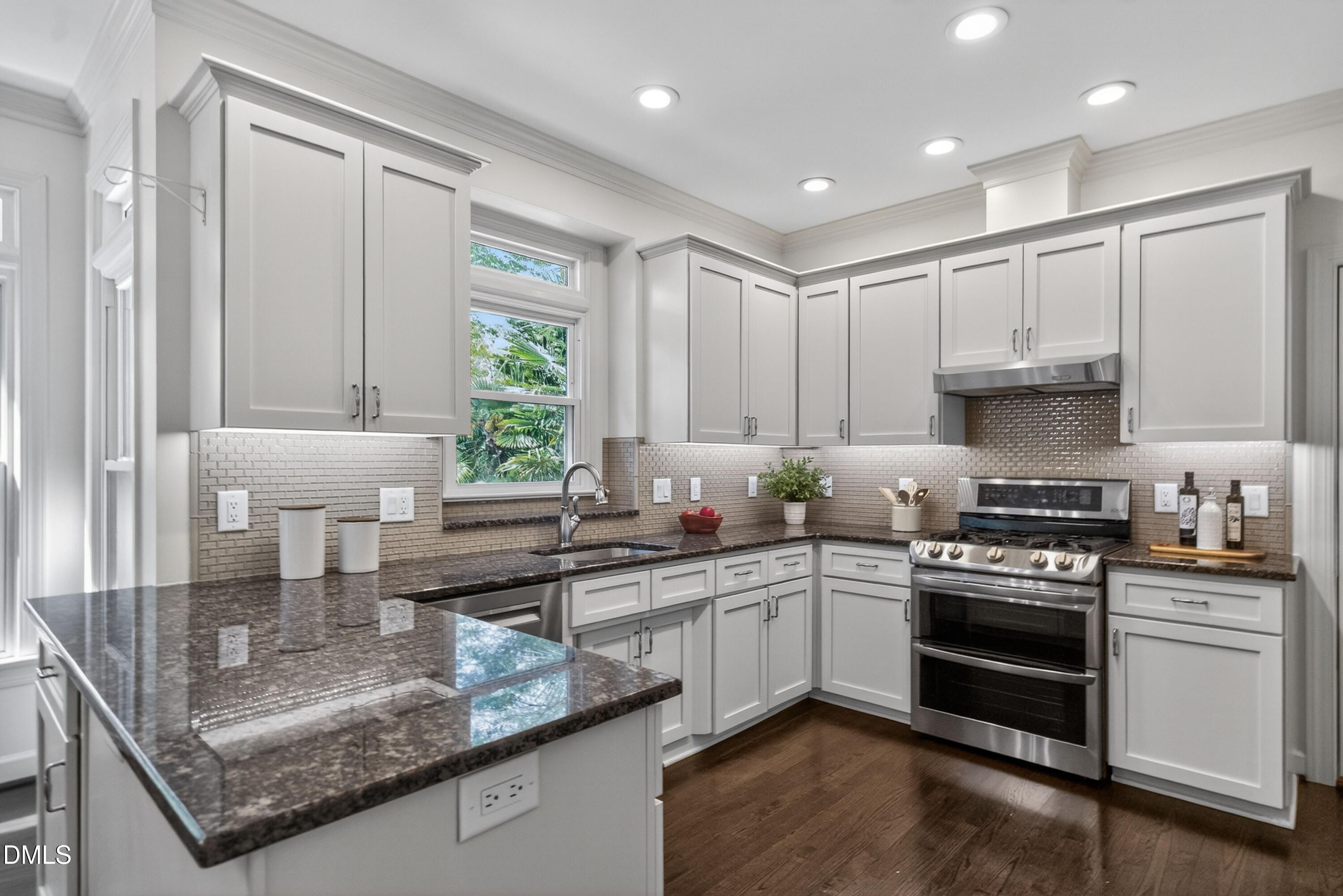 4021 Westwood Place Raleigh, NC 27613 - Photo 13 of 37 a kitchen with stainless steel appliances granite countertop a sink stove and cabinets