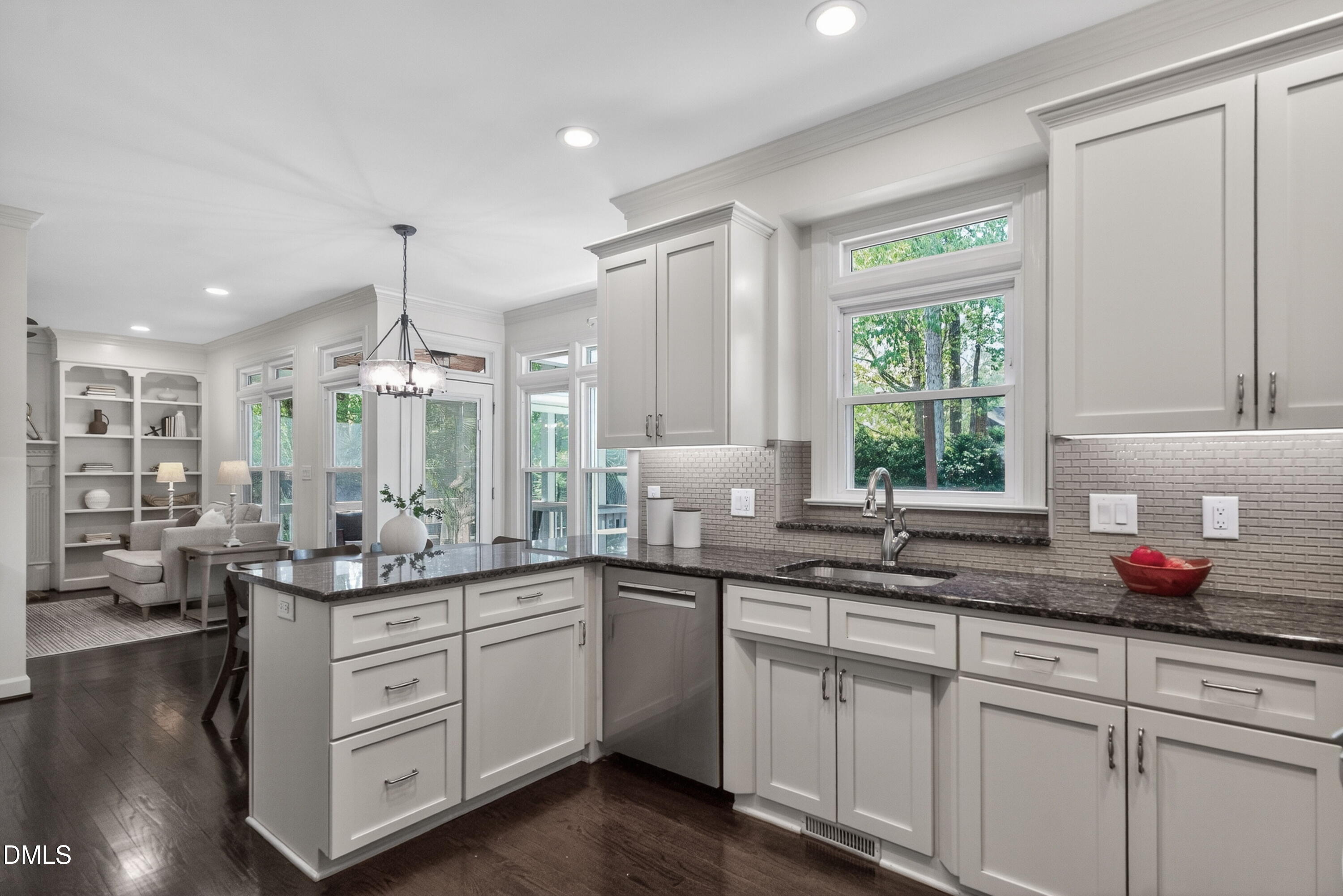 4021 Westwood Place Raleigh, NC 27613 - Photo 14 of 37 a kitchen with granite countertop a sink white cabinets and wooden floors