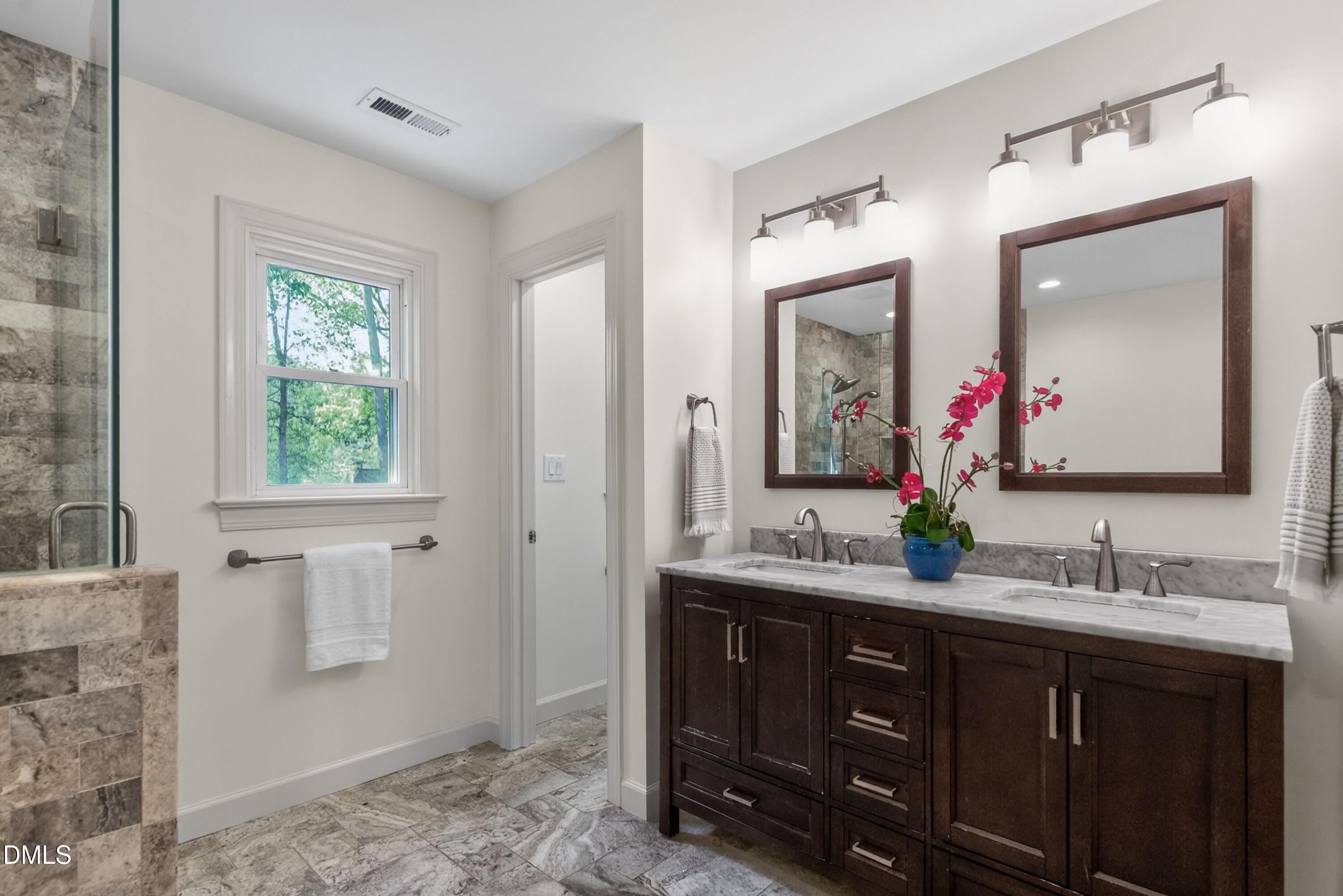 4021 Westwood Place Raleigh, NC 27613 - Photo 18 of 37 a bathroom with a double vanity sink and a mirror