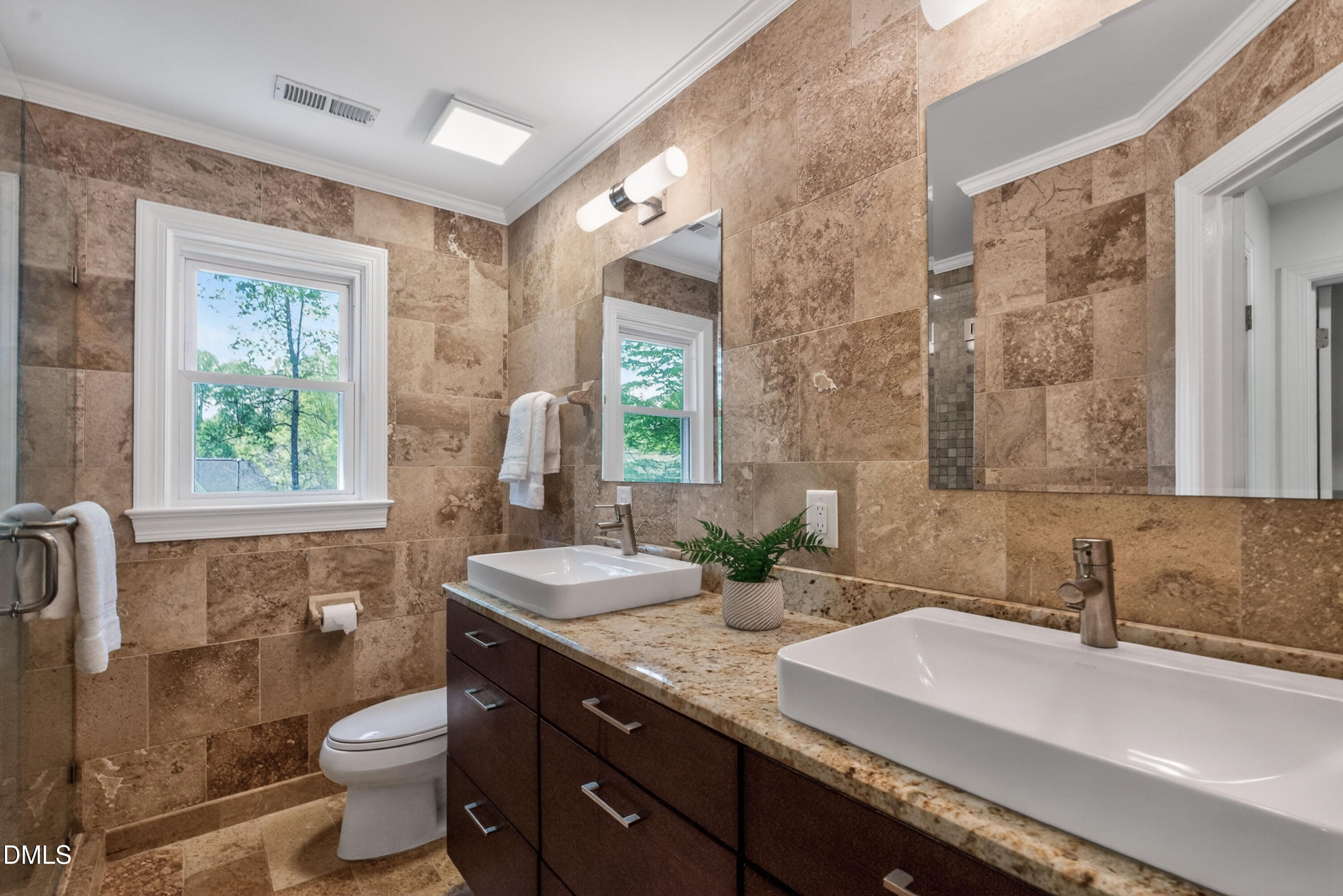 4021 Westwood Place Raleigh, NC 27613 - Photo 22 of 37 a bathroom with a double vanity sink toilet and a mirror