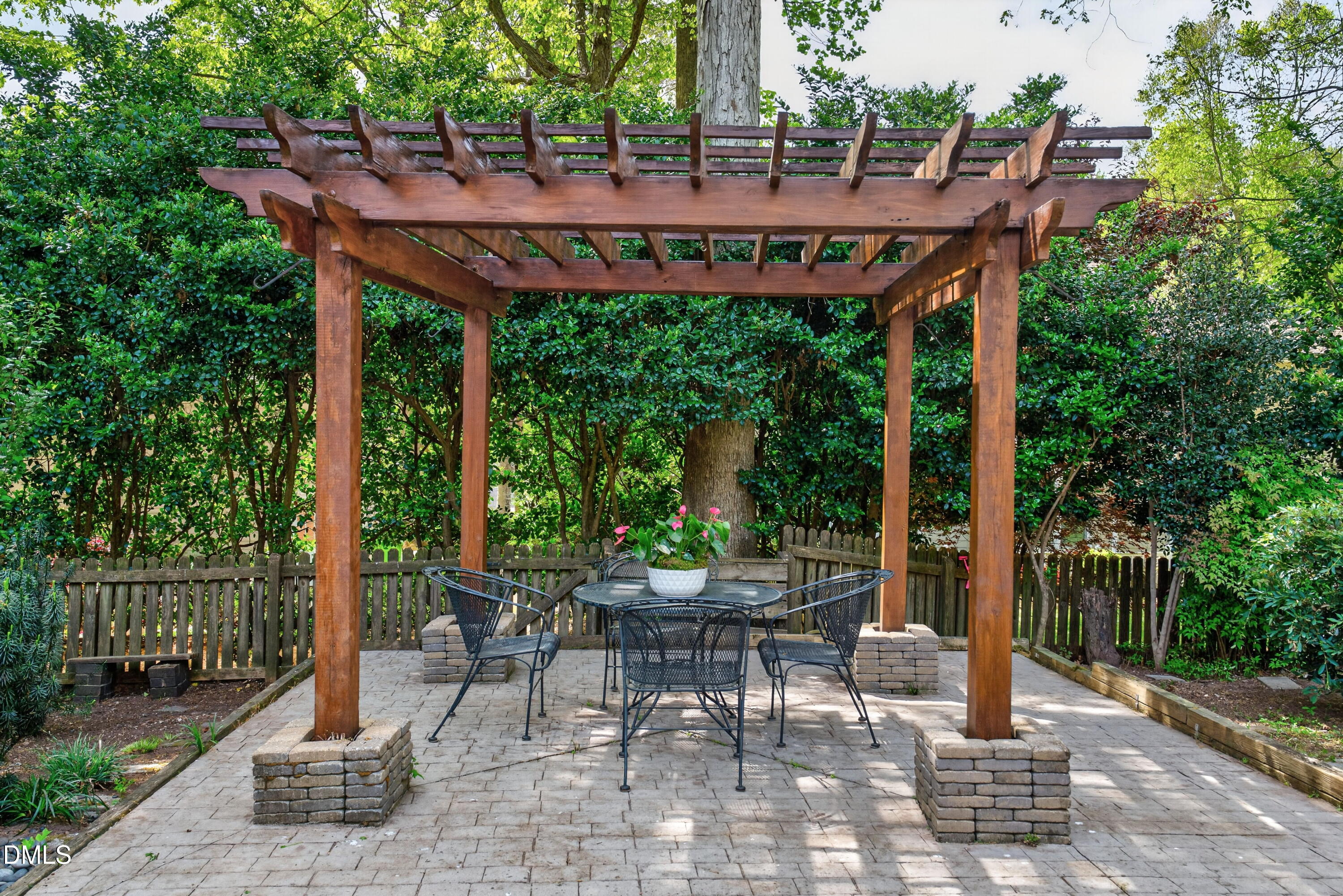 4021 Westwood Place Raleigh, NC 27613 - Photo 33 of 37 a view of a patio with table and chairs potted plants and palm tree