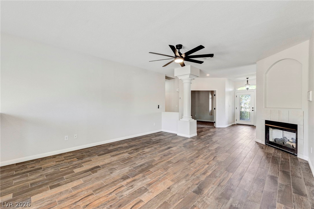 740 Aldo Rae Court, Unit NONE Henderson, NV 89052 - Photo 10 of 35 A spacious living room features wood-look tile flooring and a sleek fireplace.