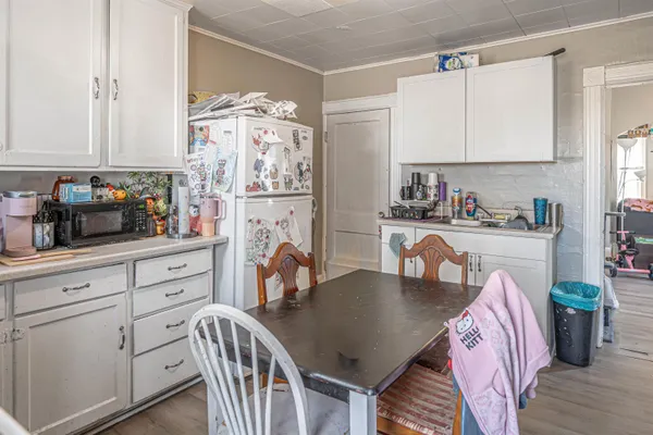a kitchen with stainless steel appliances a sink a table and chairs