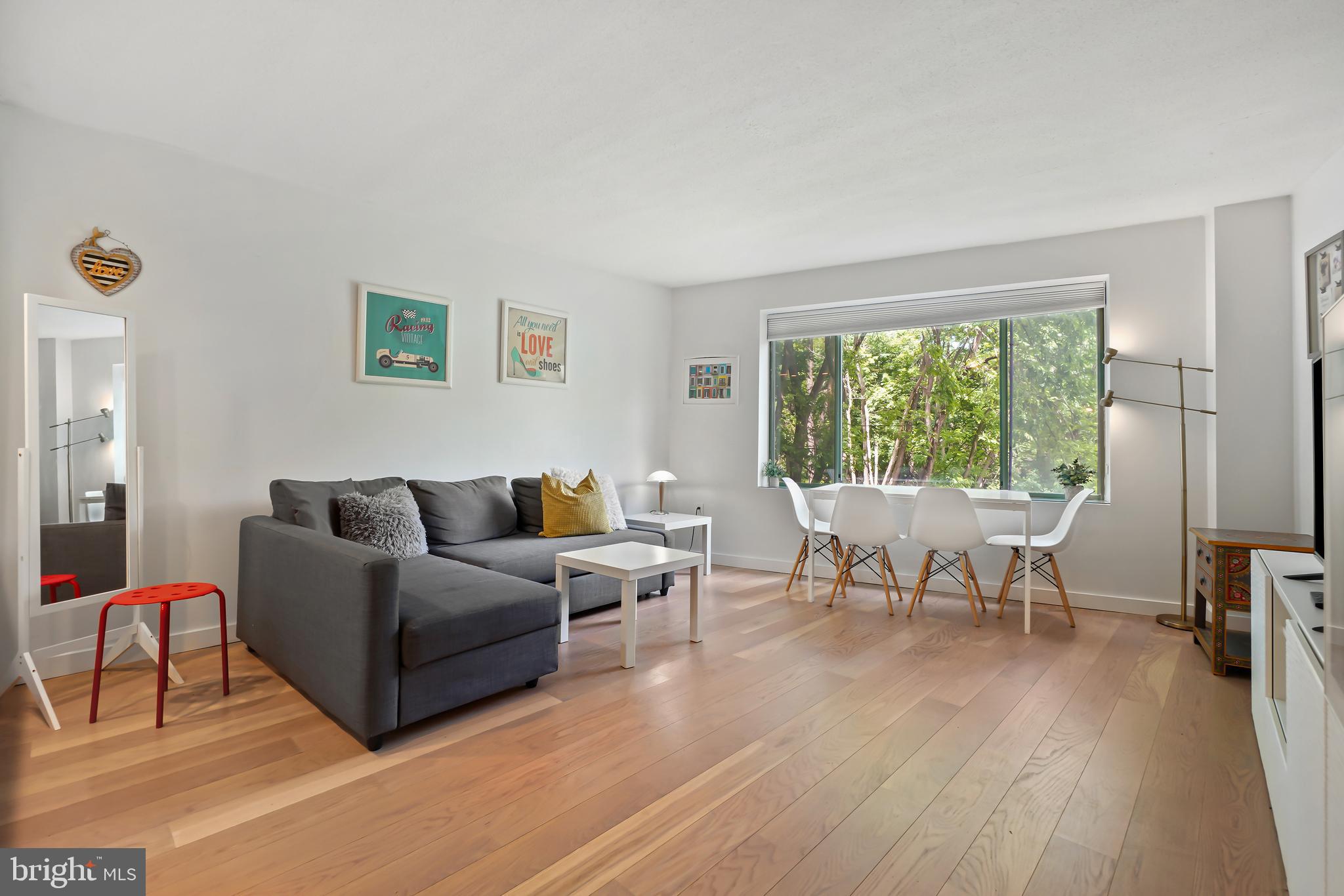 2141 Wisconsin Avenue Northwest, Unit 103 Washington, DC 20007 - Photo 14 of 30 a living room with furniture and a wooden floor