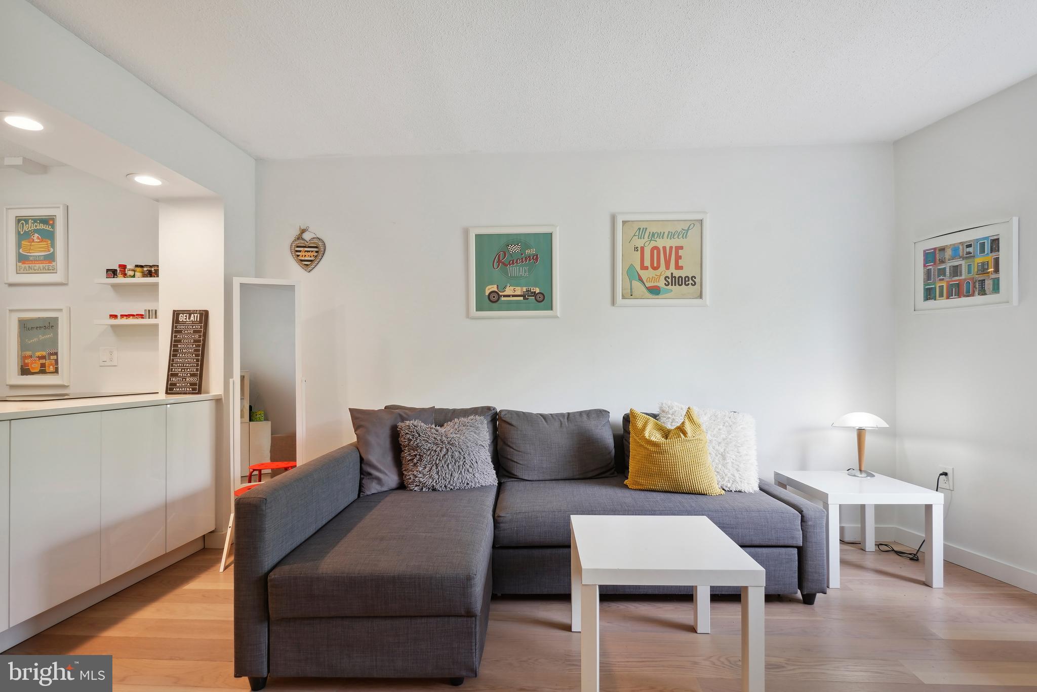 2141 Wisconsin Avenue Northwest, Unit 103 Washington, DC 20007 - Photo 15 of 30 a living room with furniture and a couch