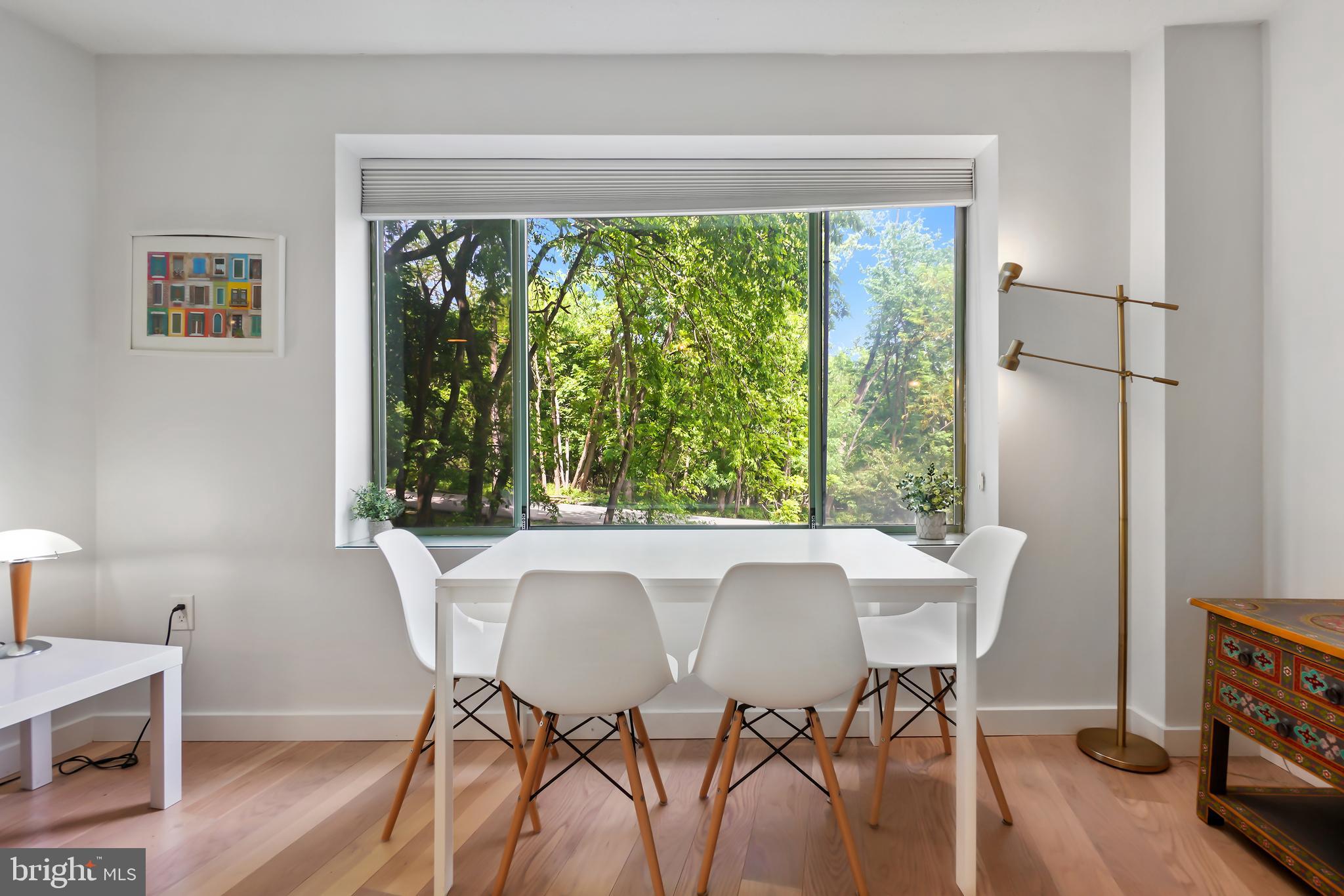 2141 Wisconsin Avenue Northwest, Unit 103 Washington, DC 20007 - Photo 18 of 30 a view of a dining room with furniture window and wooden floor
