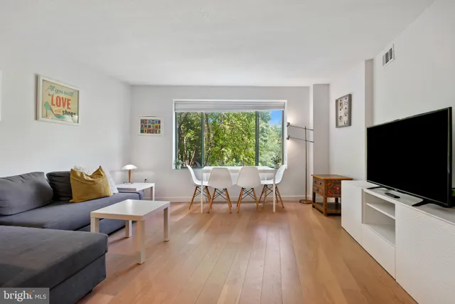 a bathroom with a toilet sink vanity and mirror