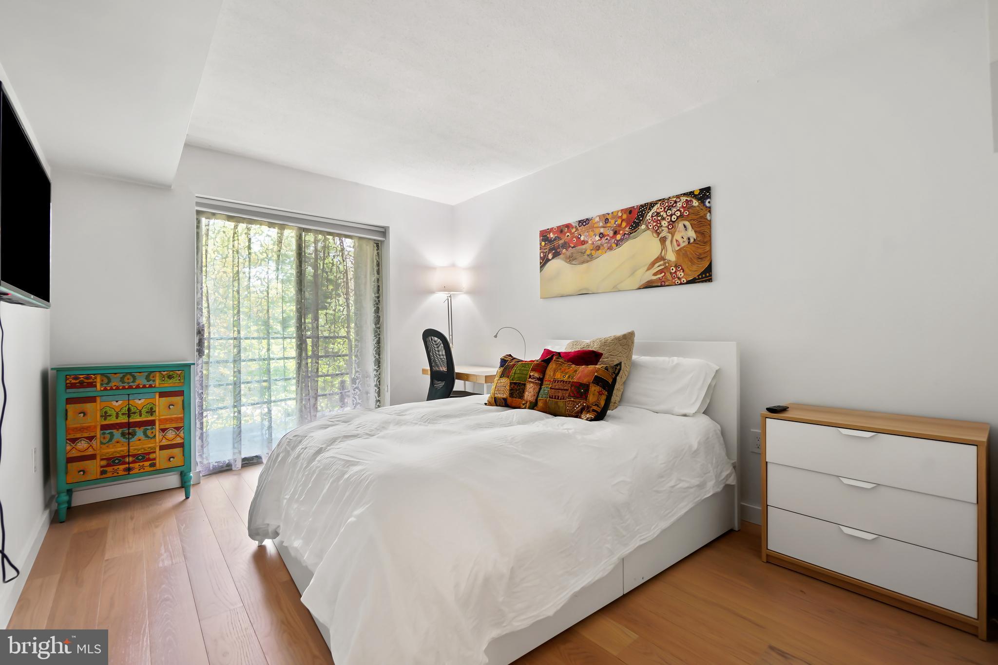 2141 Wisconsin Avenue Northwest, Unit 103 Washington, DC 20007 - Photo 22 of 30 a bedroom with a bed and a flat tv screen