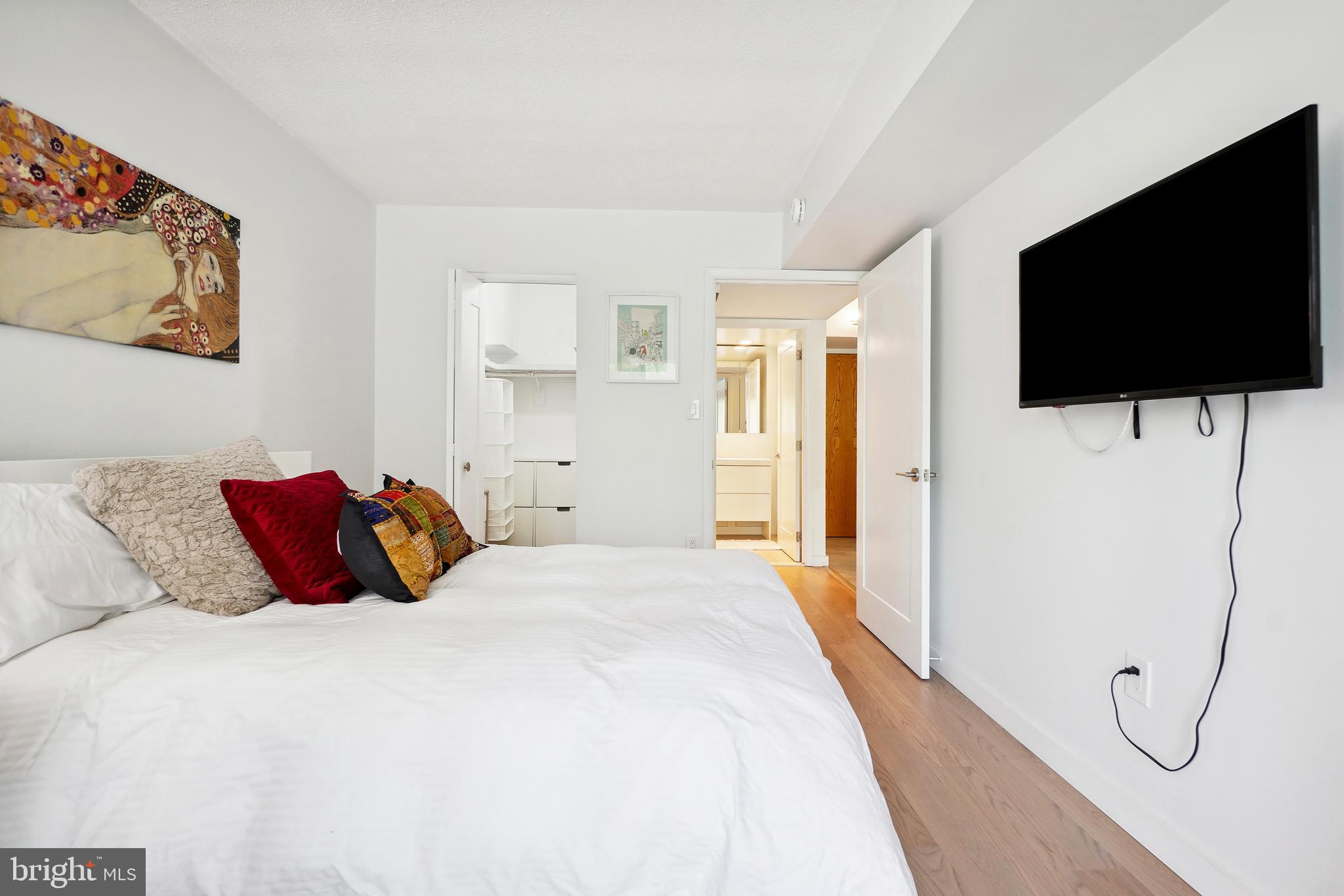 2141 Wisconsin Avenue Northwest, Unit 103 Washington, DC 20007 - Photo 24 of 30 a bedroom with a bed and a flat screen tv