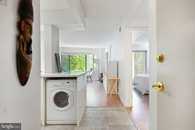a view of a bedroom with washer and dryer