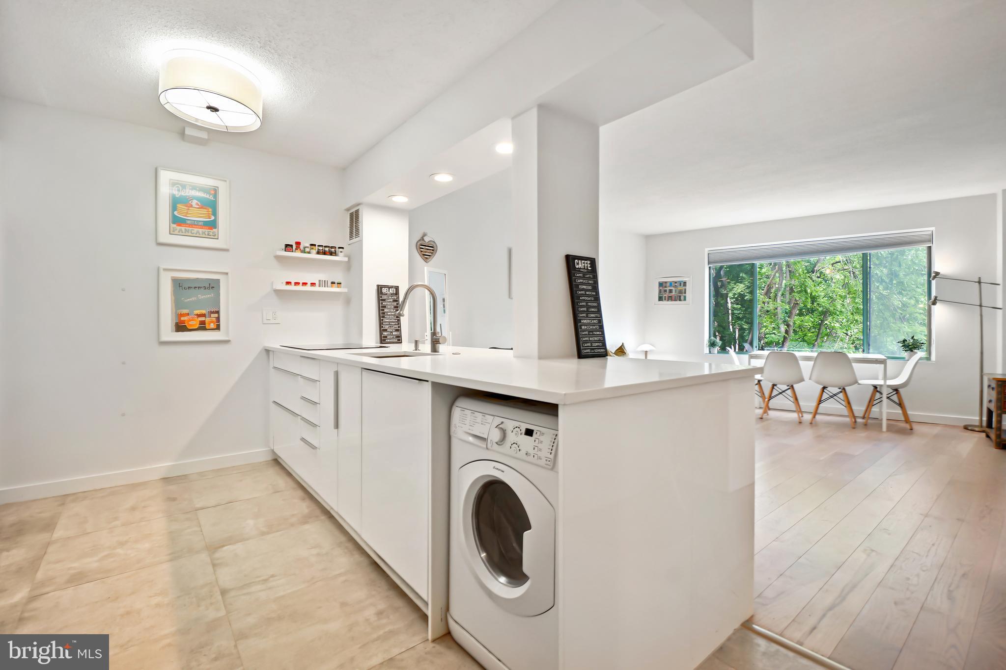 2141 Wisconsin Avenue Northwest, Unit 103 Washington, DC 20007 - Photo 7 of 30 a view of living room with granite countertop furniture and a fireplace