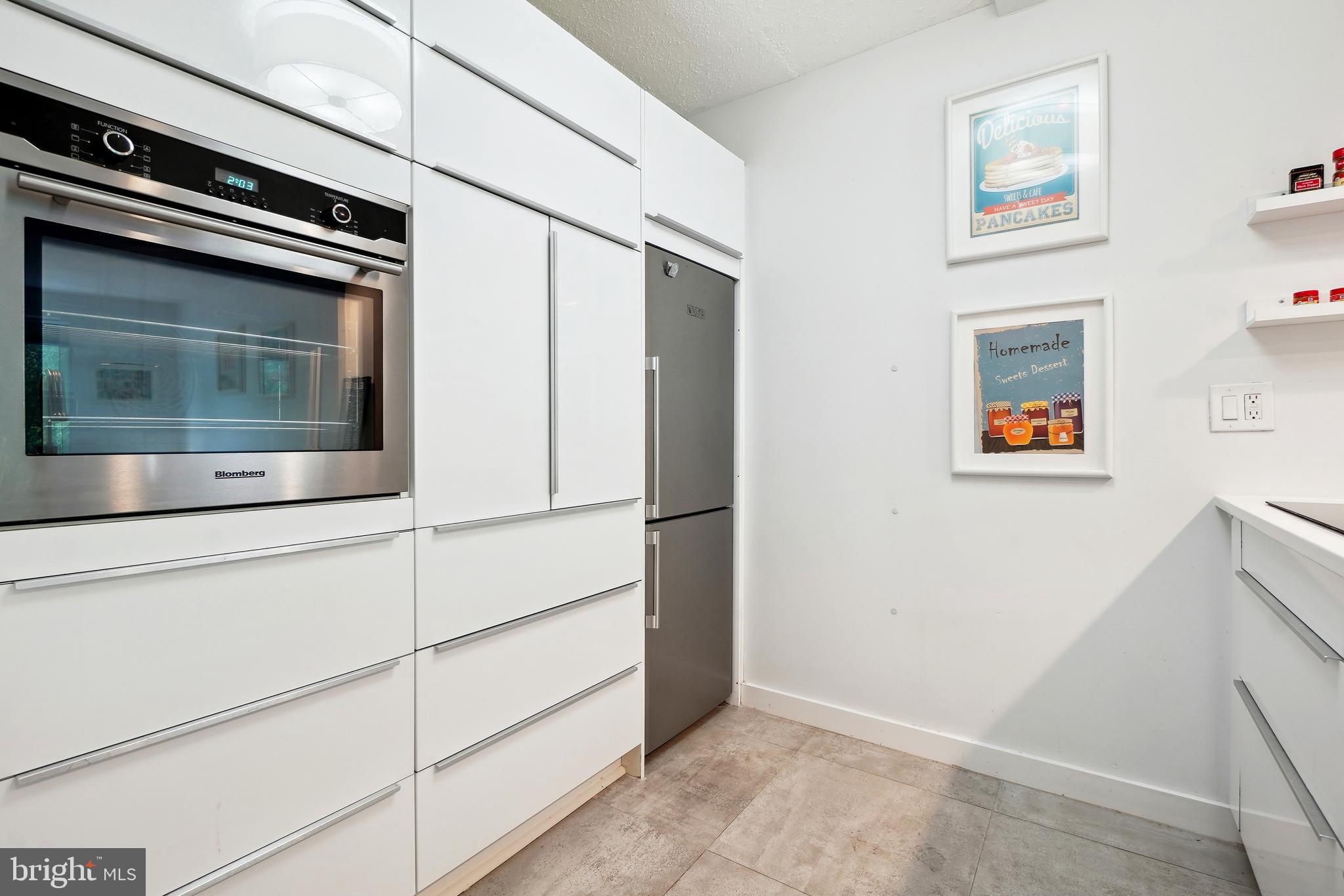 2141 Wisconsin Avenue Northwest, Unit 103 Washington, DC 20007 - Photo 8 of 30 a kitchen with stainless steel appliances and cabinets