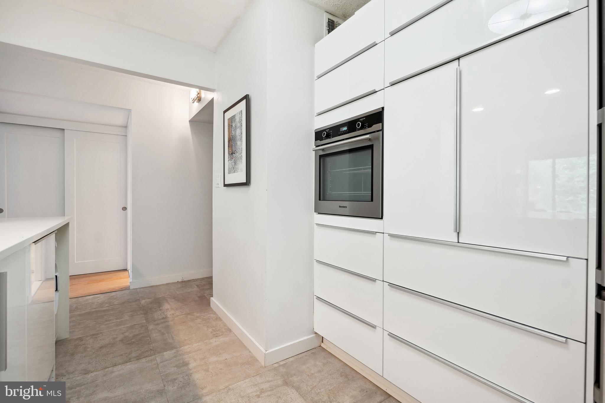2141 Wisconsin Avenue Northwest, Unit 103 Washington, DC 20007 - Photo 10 of 30 a view of kitchen with stainless steel appliances cabinets and refrigerator