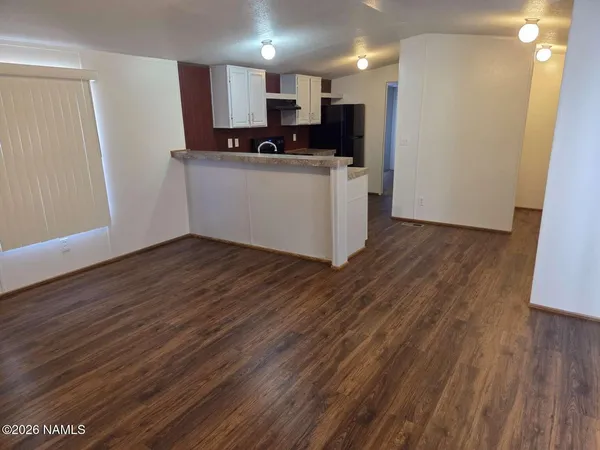 a kitchen with stainless steel appliances a refrigerator and a stove top oven