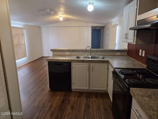 a kitchen with a sink and a stove top oven