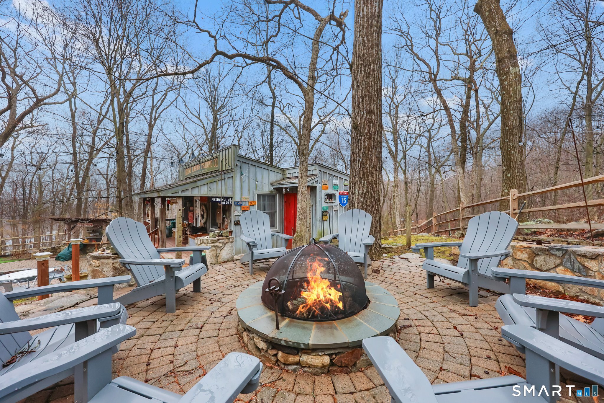 142 Seventy Acre Road Redding, CT 06896 - Photo 26 of 40 a patio with sofas table and chairs and a fire pit