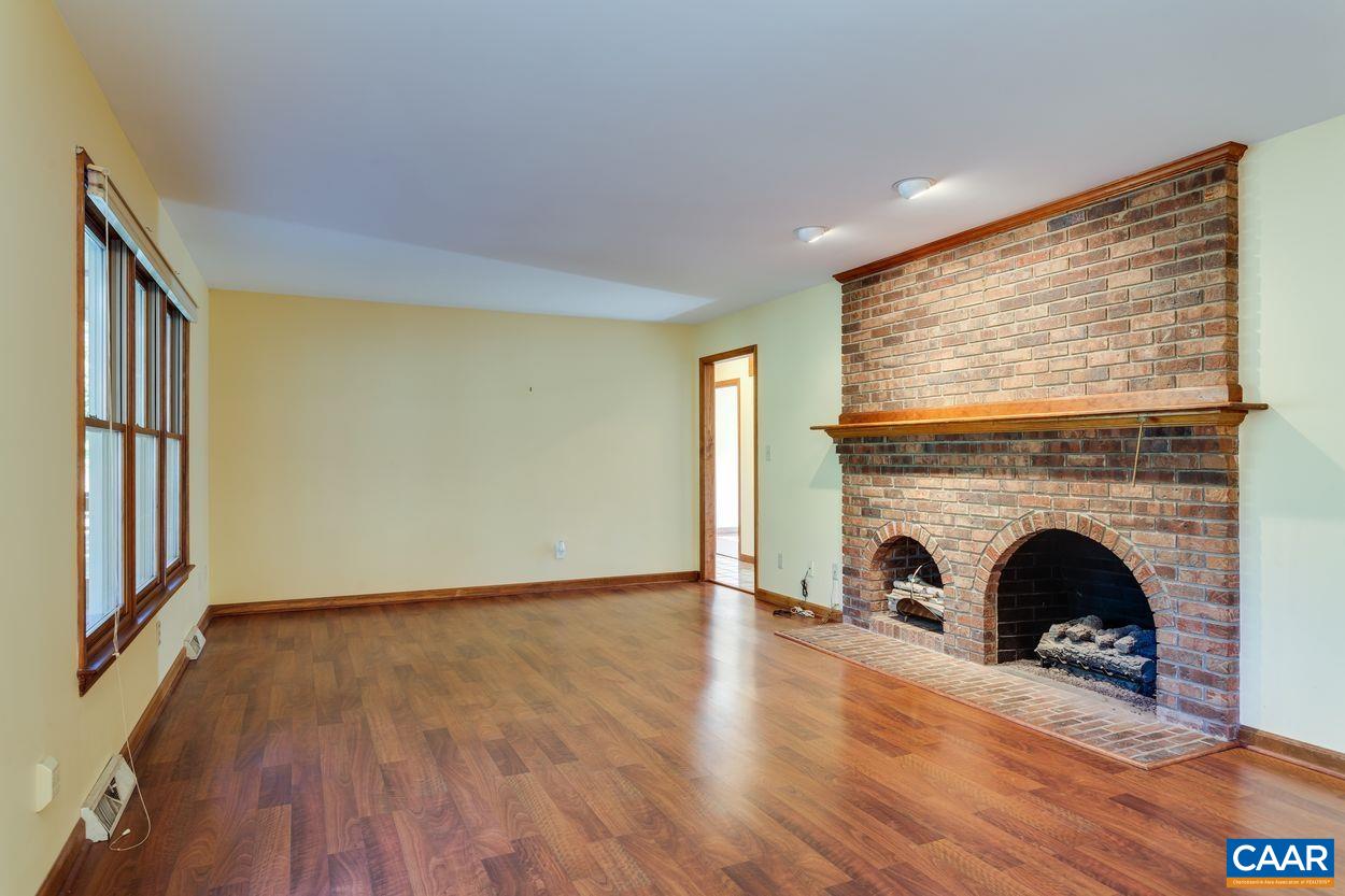 5904 Free Union Road Free Union, VA 22940 - Photo 19 of 75 a view of an empty room with wooden floor and a fireplace