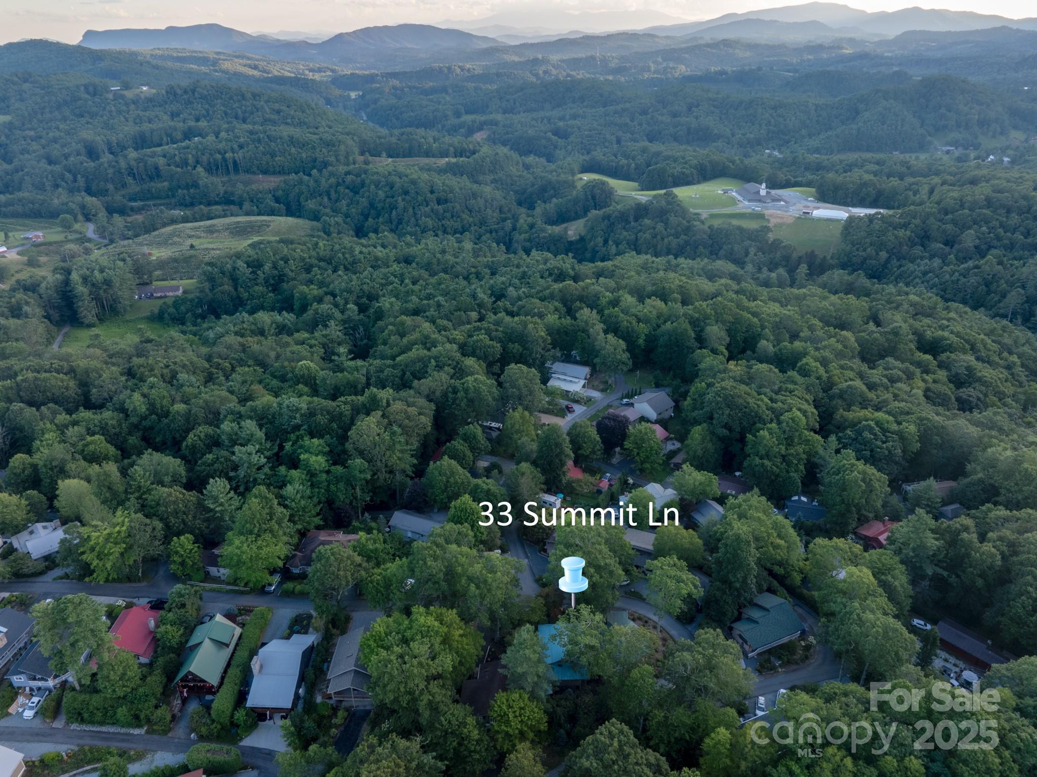 33 Summit Lane Newland, NC 28657 - Photo 3 of 48 an aerial view of a houses with a lush green hillside