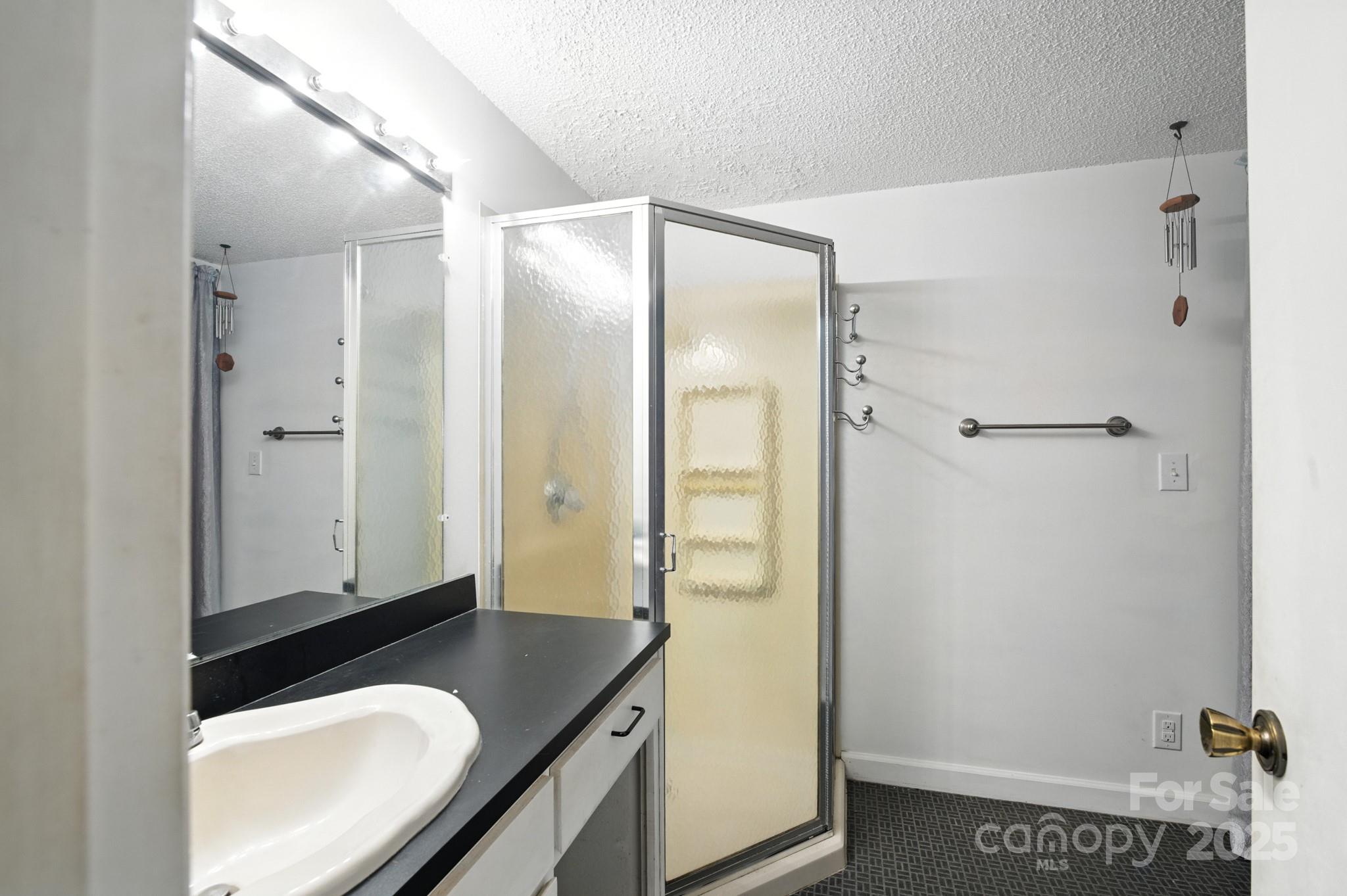 33 Summit Lane Newland, NC 28657 - Photo 47 of 48 a bathroom with a granite countertop sink and a mirror