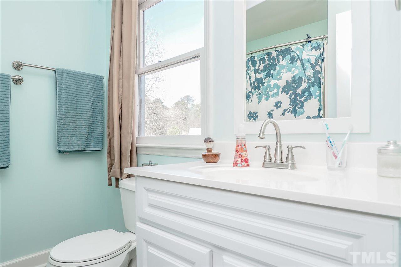 1713 Vintage Road Raleigh, NC 27610 - Photo 18 of 23 a bathroom with a sink toilet and window