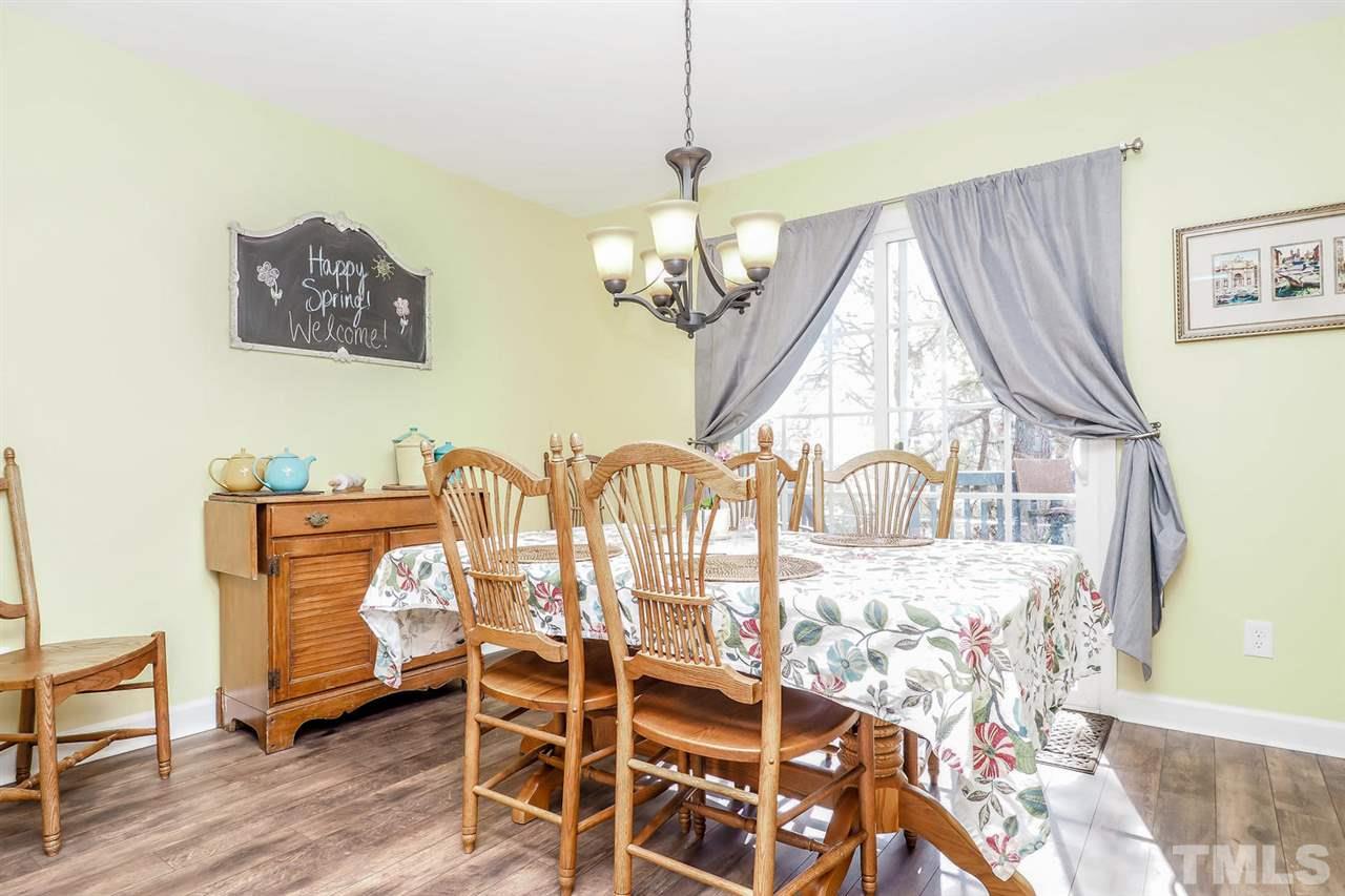 1713 Vintage Road Raleigh, NC 27610 - Photo 6 of 23 a view of a dining room with furniture and wooden floor