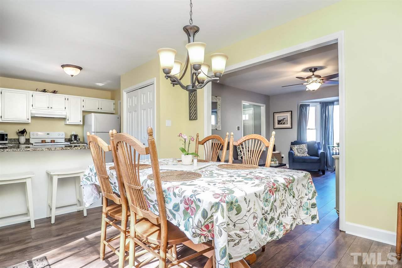 1713 Vintage Road Raleigh, NC 27610 - Photo 7 of 23 a view of a dining room with furniture and a chandelier