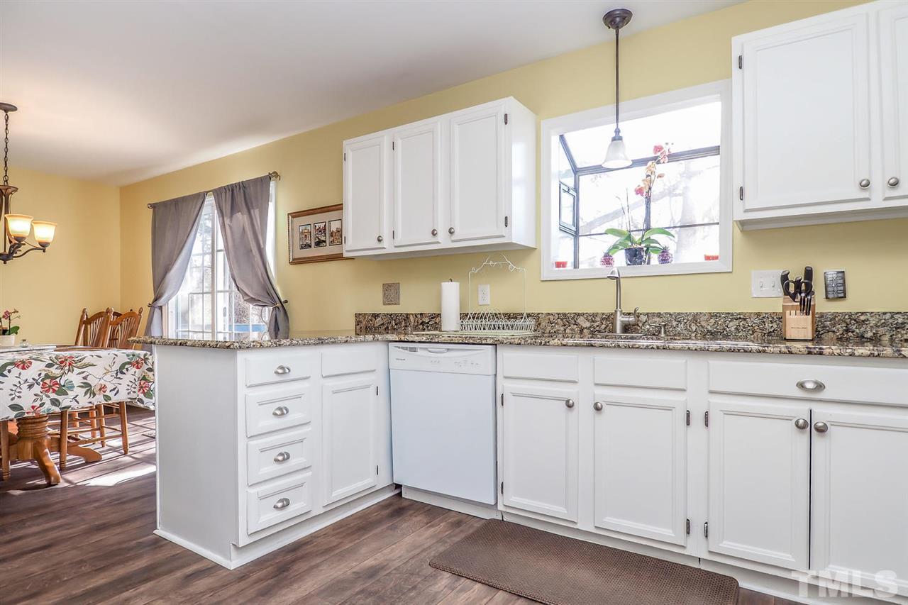 1713 Vintage Road Raleigh, NC 27610 - Photo 9 of 23 a kitchen with granite countertop white cabinets white stainless steel appliances and sink