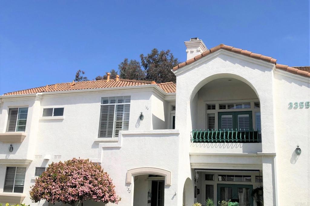 3355 Genoa Way, Unit 134 Oceanside, CA 92056 - Photo 12 of 45 a view of a white building with large windows