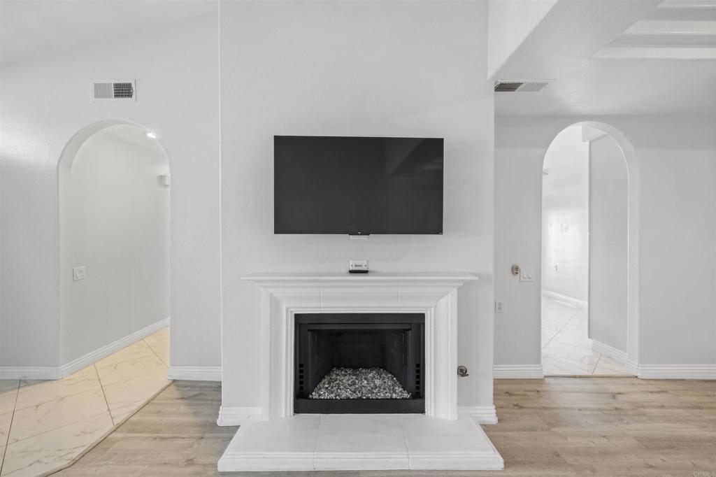 3355 Genoa Way, Unit 134 Oceanside, CA 92056 - Photo 16 of 45 a living room with furniture a fireplace and a flat screen tv