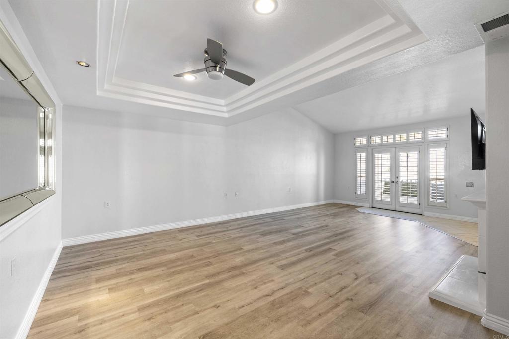 3355 Genoa Way, Unit 134 Oceanside, CA 92056 - Photo 17 of 45 a view of an empty room with wooden floor and a window