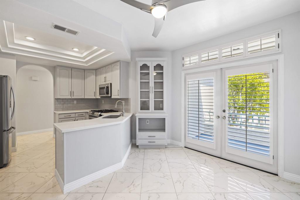 3355 Genoa Way, Unit 134 Oceanside, CA 92056 - Photo 18 of 45 a kitchen with a stove a refrigerator and a cabinets