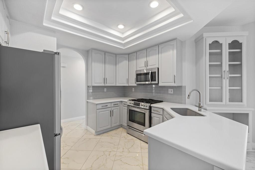 3355 Genoa Way, Unit 134 Oceanside, CA 92056 - Photo 20 of 45 a kitchen with stainless steel appliances granite countertop a stove sink and cabinets